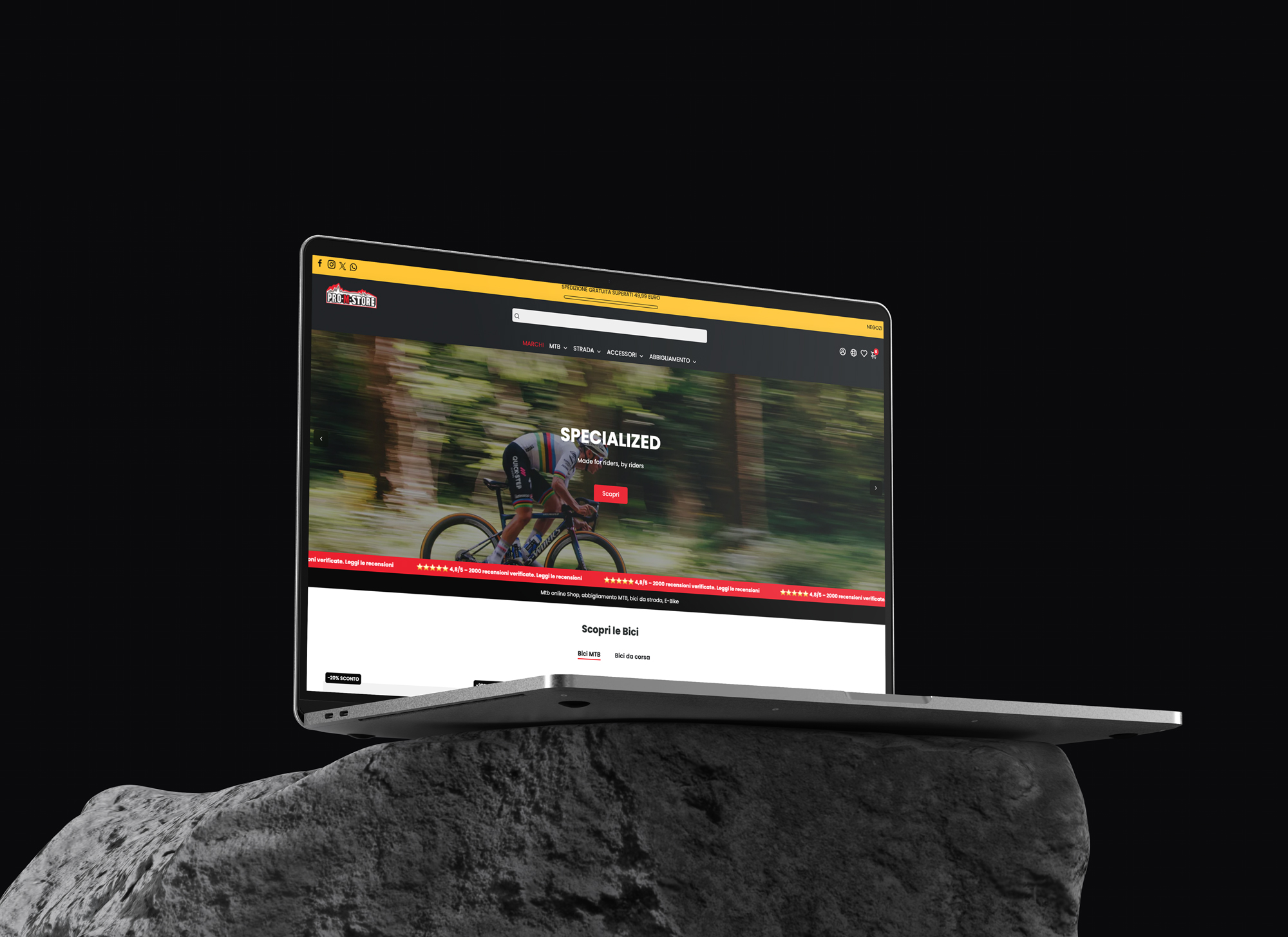 Macbook su un sasso con sfondo nero di un sito di biciclette